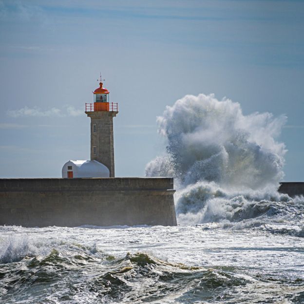 Lighthouse with crashing waves